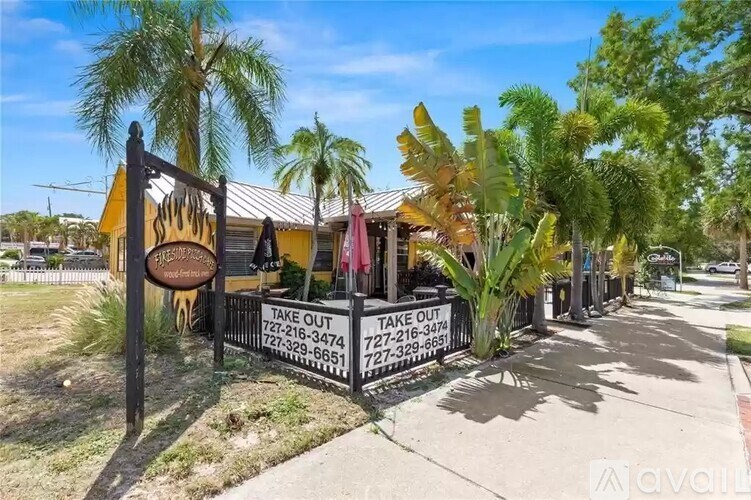 A yellow building with a sign that says "Take Out" in front of it.