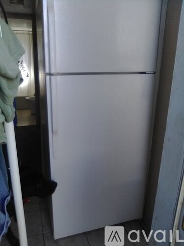 A white refrigerator is in a kitchen.
