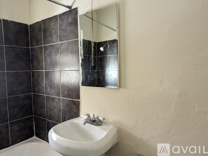 A bathroom with a white sink and a mirror.