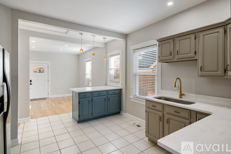 A kitchen with a white countertop and a blue cabinet.