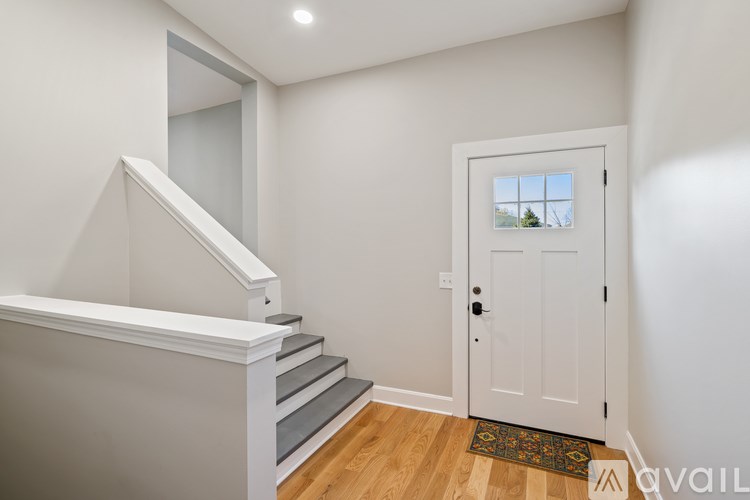 A white door with a window above it in a room.