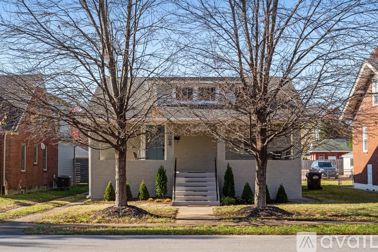A house with a tree in front of it.