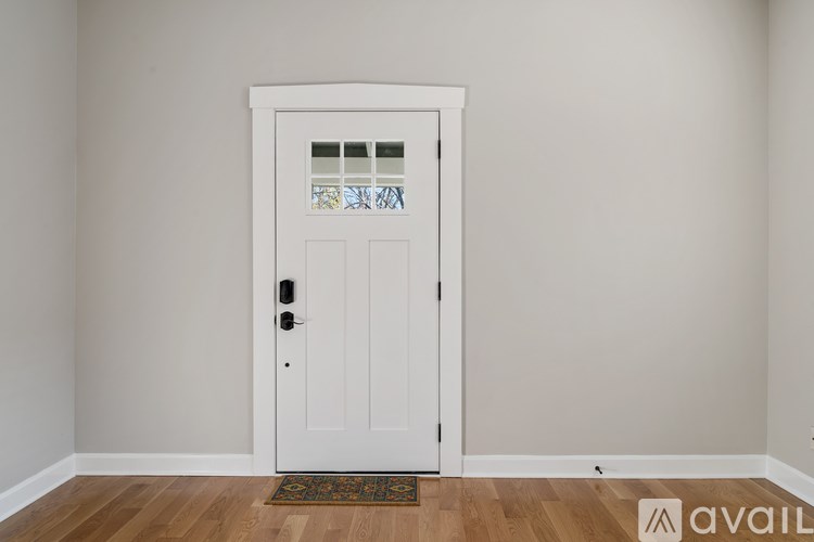 A white door with a glass window and a doorknob.