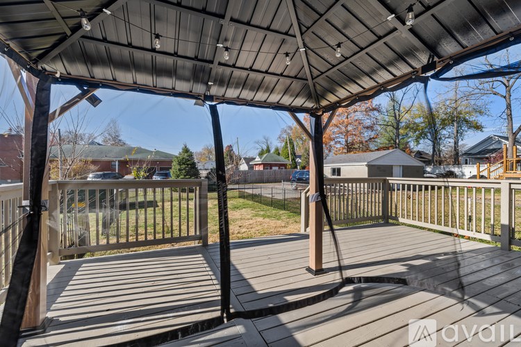 A wooden deck with a metal roof and a hose attached to it.