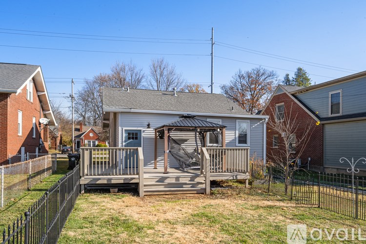 A house with a grey roof and a white garage door.