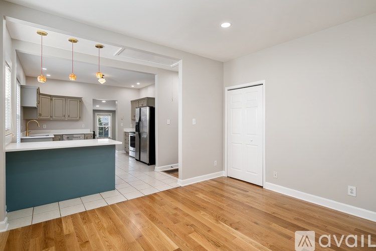 A kitchen with a refrigerator, sink, and cabinets is available for rent.