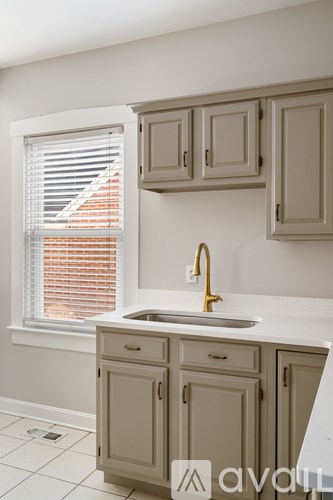 A kitchen with a sink and cabinets.