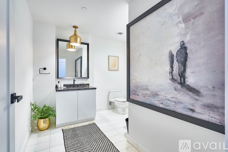 A bathroom with a large mirror and a painting on the wall.