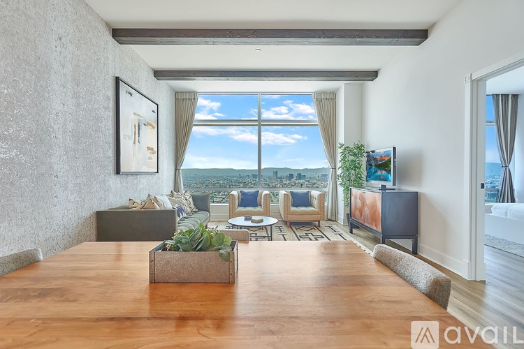 A living room with a large window overlooking the city.