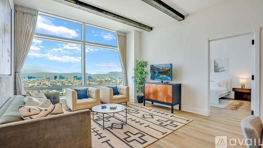 A living room with a large window overlooking a cityscape.
