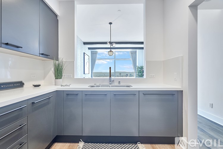 A modern kitchen with a large window and a sink.
