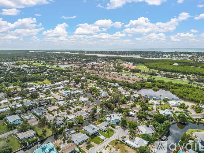 A bird's eye view of a residential area with houses and greenery.
