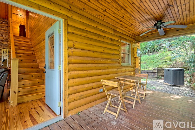 A wooden deck with a table and chairs is shown.