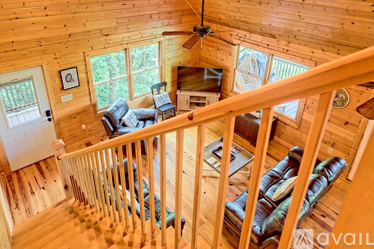 A living room with a couch and a television.