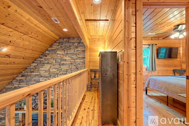 A wooden staircase with a stone wall on one side and a wooden railing on the other.