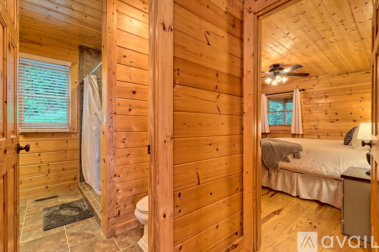 A wooden room with a bed and a window.