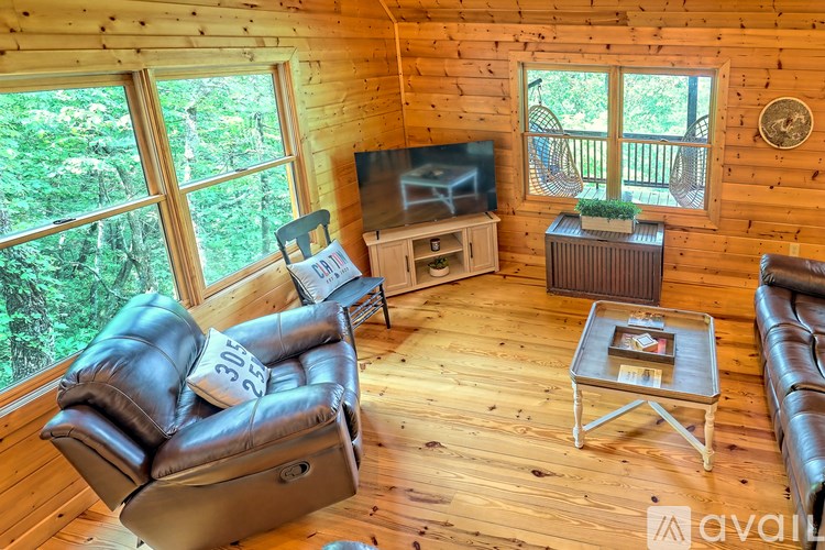 A living room with a leather chair and a flat screen TV.