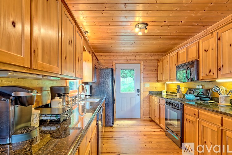A kitchen with wooden cabinets and granite countertops.