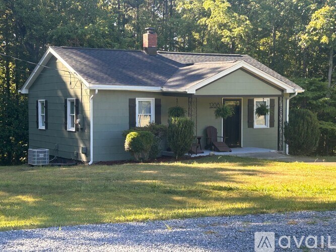 A house with a grey roof and a porch.
