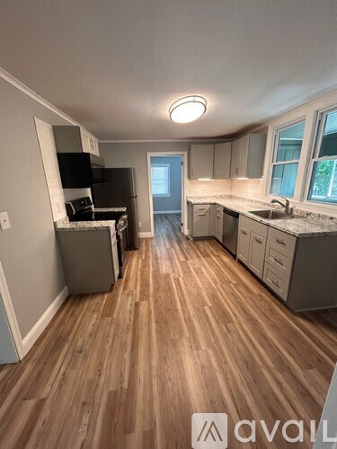 A kitchen with wooden floors and a countertop.