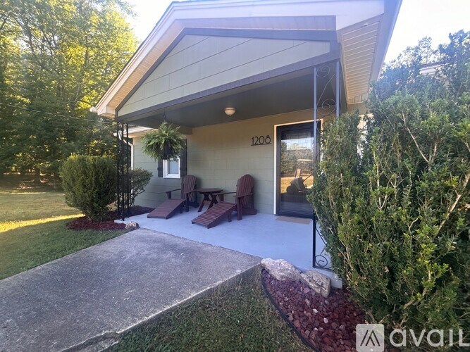 A house numbered 120 is surrounded by greenery.