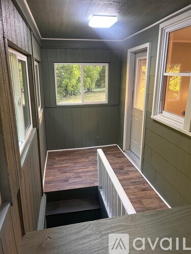 A room with a window and a wooden table.