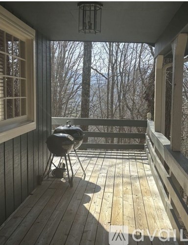 A porch with a grill and a lantern.