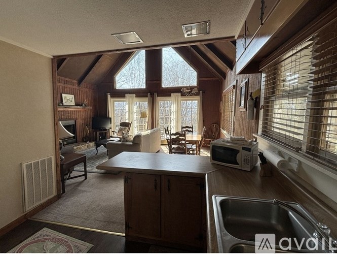 A living room with a kitchen area in the foreground.