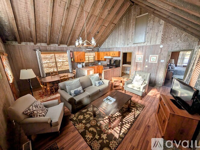 A living room with a couch, chairs, and a coffee table.