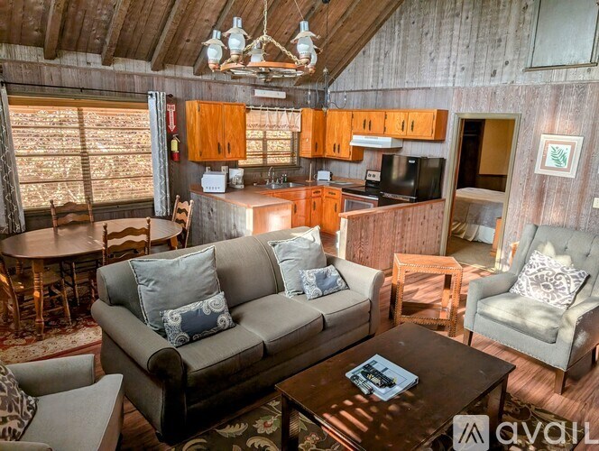 A living room with a couch, chairs, and a coffee table.