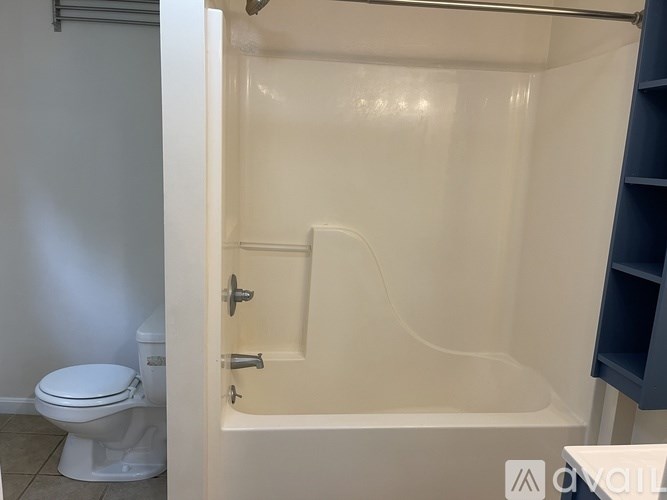 A white bathroom with a toilet and a bathtub.