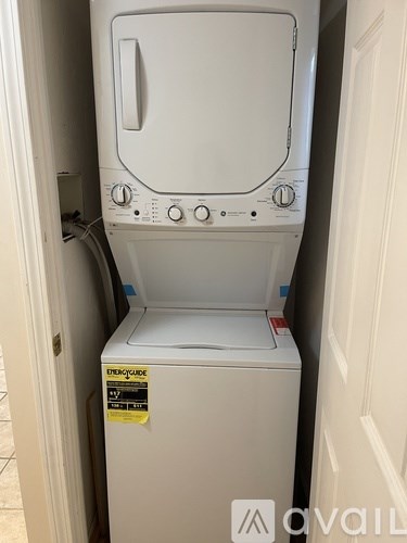 A white dryer is sitting in a doorway.