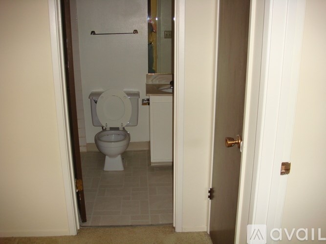 A white toilet in a small bathroom.