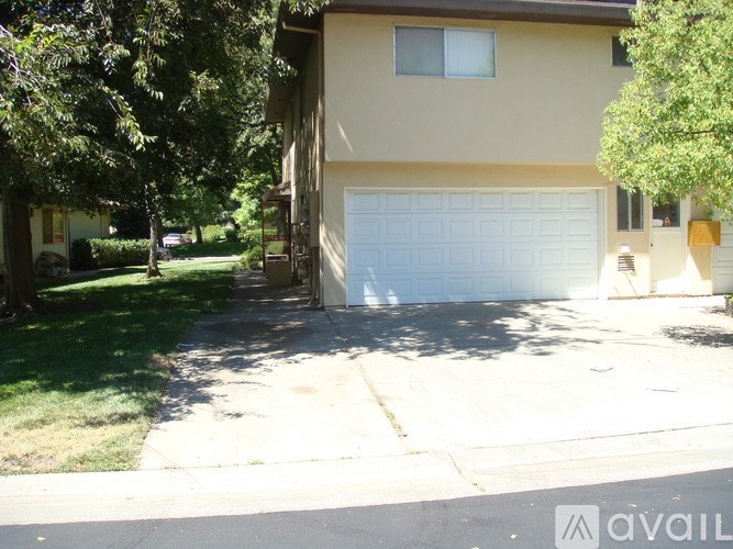 A house with a white garage door is for sale.