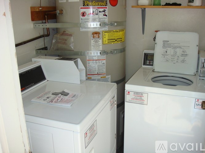 A small laundry room with a washer and dryer.