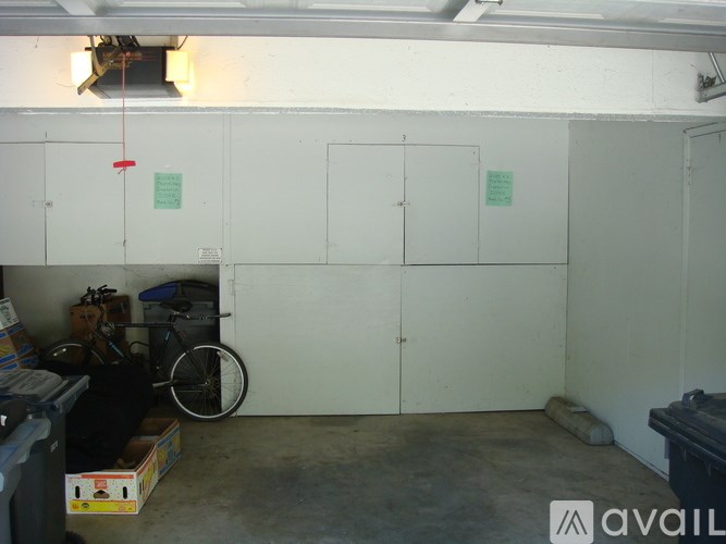 A room with a bicycle and boxes on the floor.