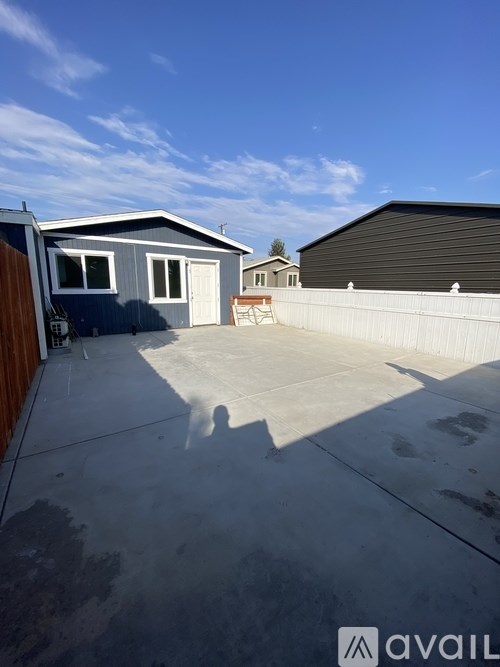 A house with a garage and a driveway in front of it.