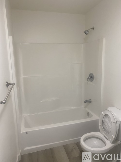 A white bathroom with a toilet and a bathtub.