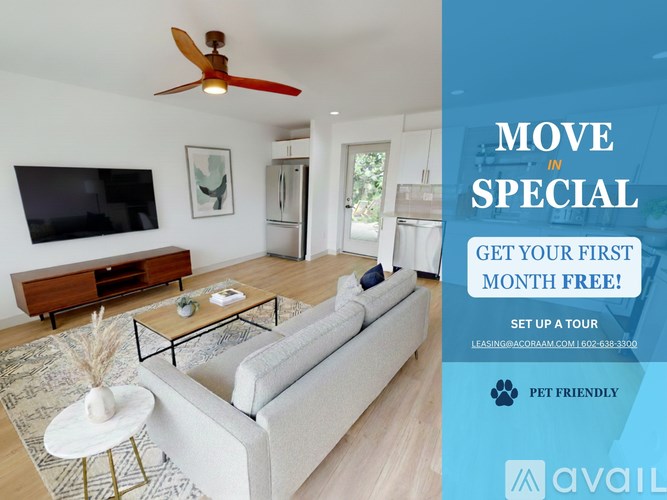 A living room with a couch, a coffee table, and a ceiling fan.