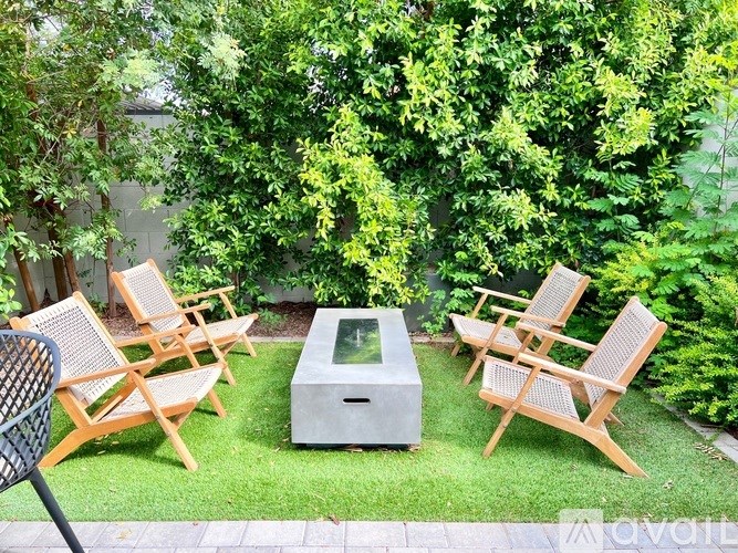 A backyard with a concrete table and chairs.