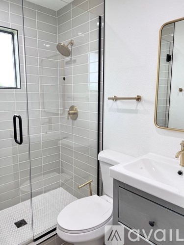 A white toilet sits next to a sink in a bathroom.