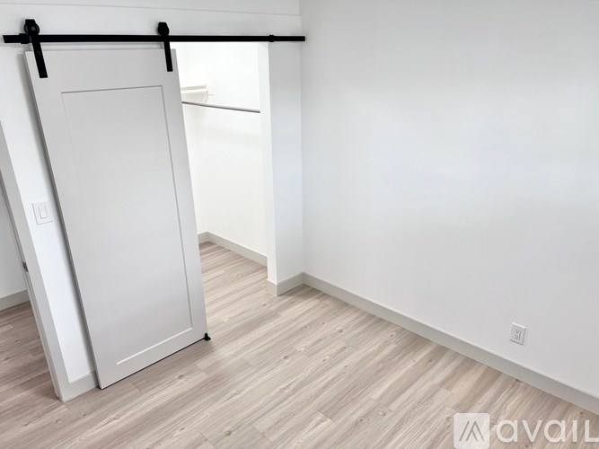 A white door is closed and has a black bar across the top.