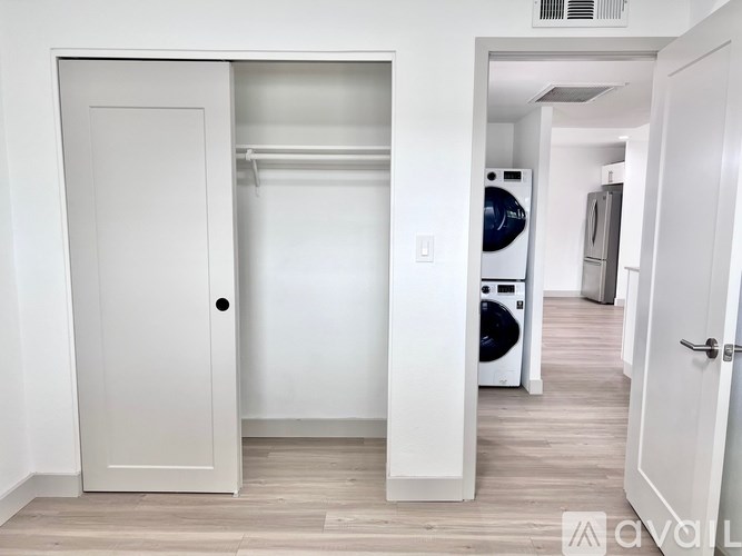 A white door is open to a laundry room.