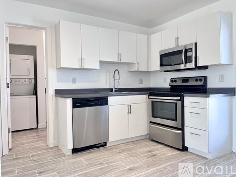 A kitchen with white cabinets and stainless steel appliances.
