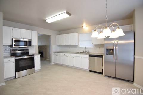 A kitchen with white cabinets and stainless steel appliances.