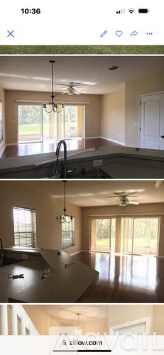 A kitchen with a ceiling fan and a dining area with a table and chairs.