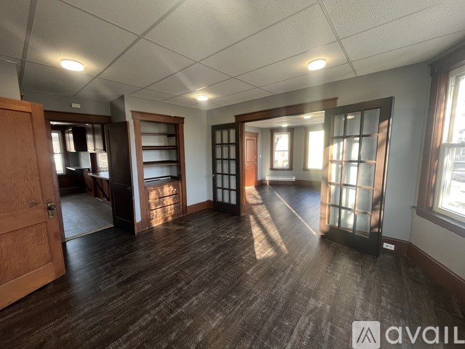 A room with wooden floors and a large window.