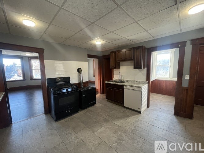 A kitchen with a black stove and white refrigerator.