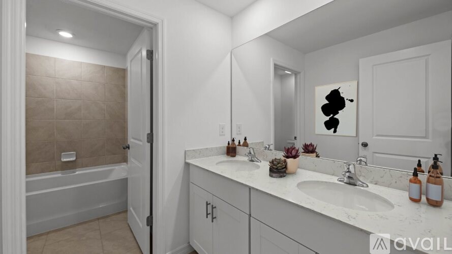 A bathroom with a white sink and a white bathtub.