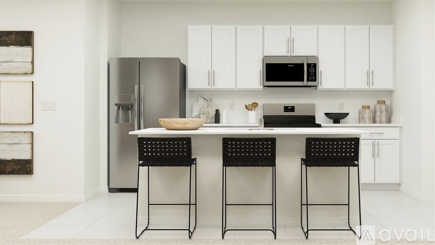 A kitchen with white cabinets and a black table.